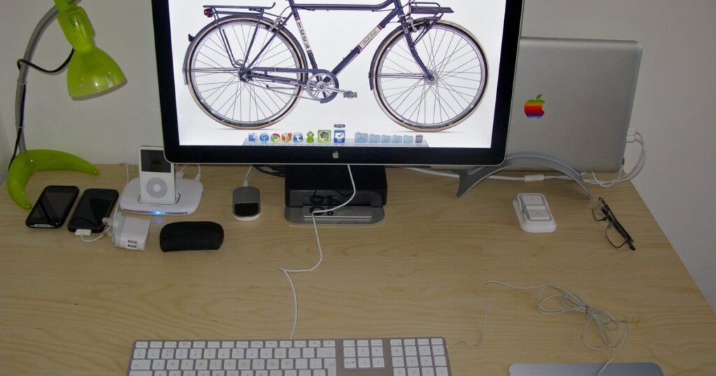 A home desk with a monitor, keyboard, and laptop, representing the kind of remote desk setup AI trainer and data-labeling work is done from